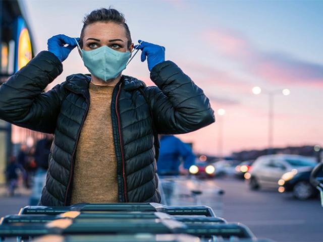 Mujer preparándose para ir de compras con máscara protectora